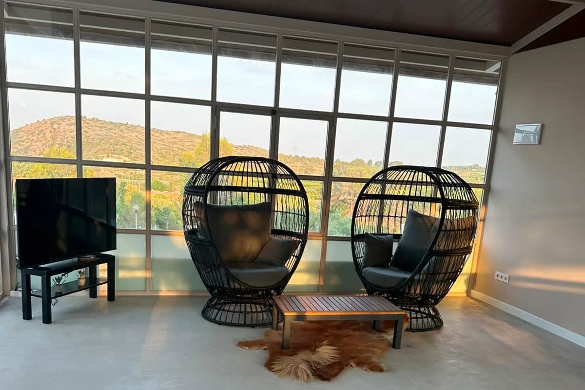 Salón de Ryfugio con ventanales y luz de atardecer